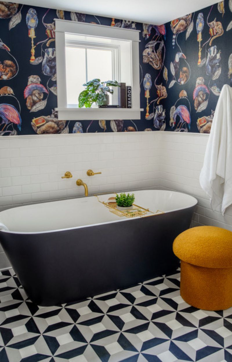 Primary Bath Renovation with lots of patterned tile, freestanding tub and wallpaper.